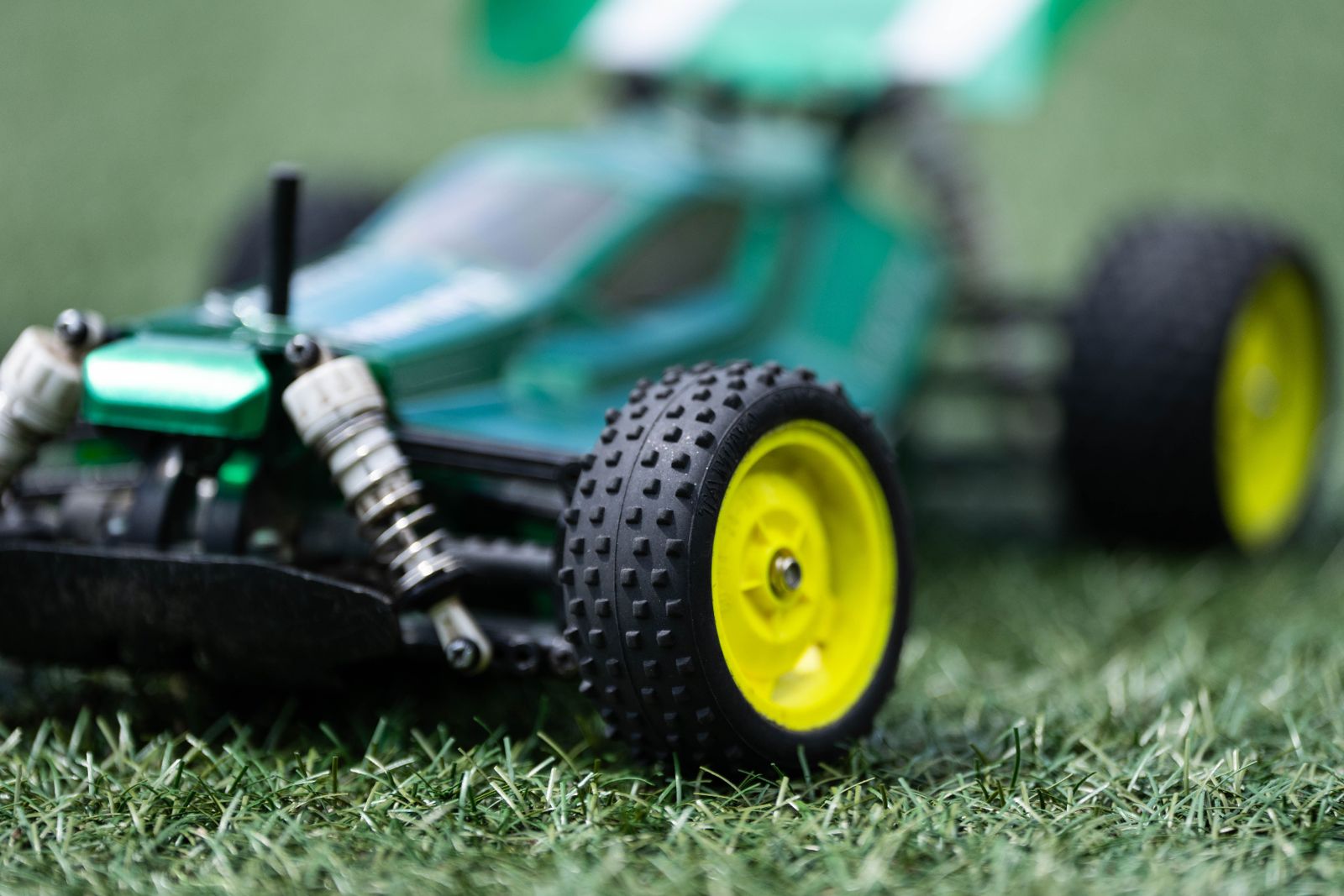 Close-up of a green Tamiya RC buggy with yellow wheels at RC Garage Vienna