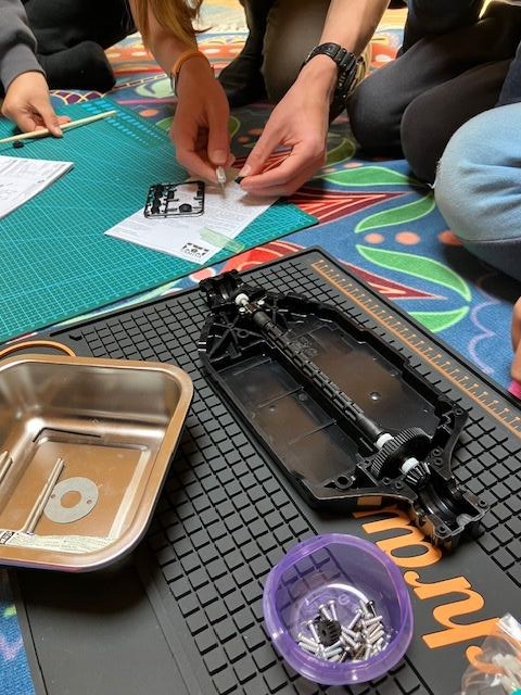 Kids building a Tamiya RC car chassis at RC Garage summer camp Vienna