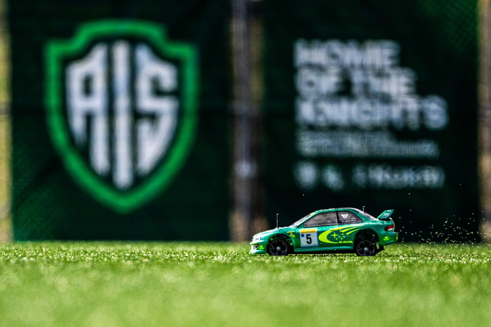RC rally car drifting through corner at AIS Vienna camp
